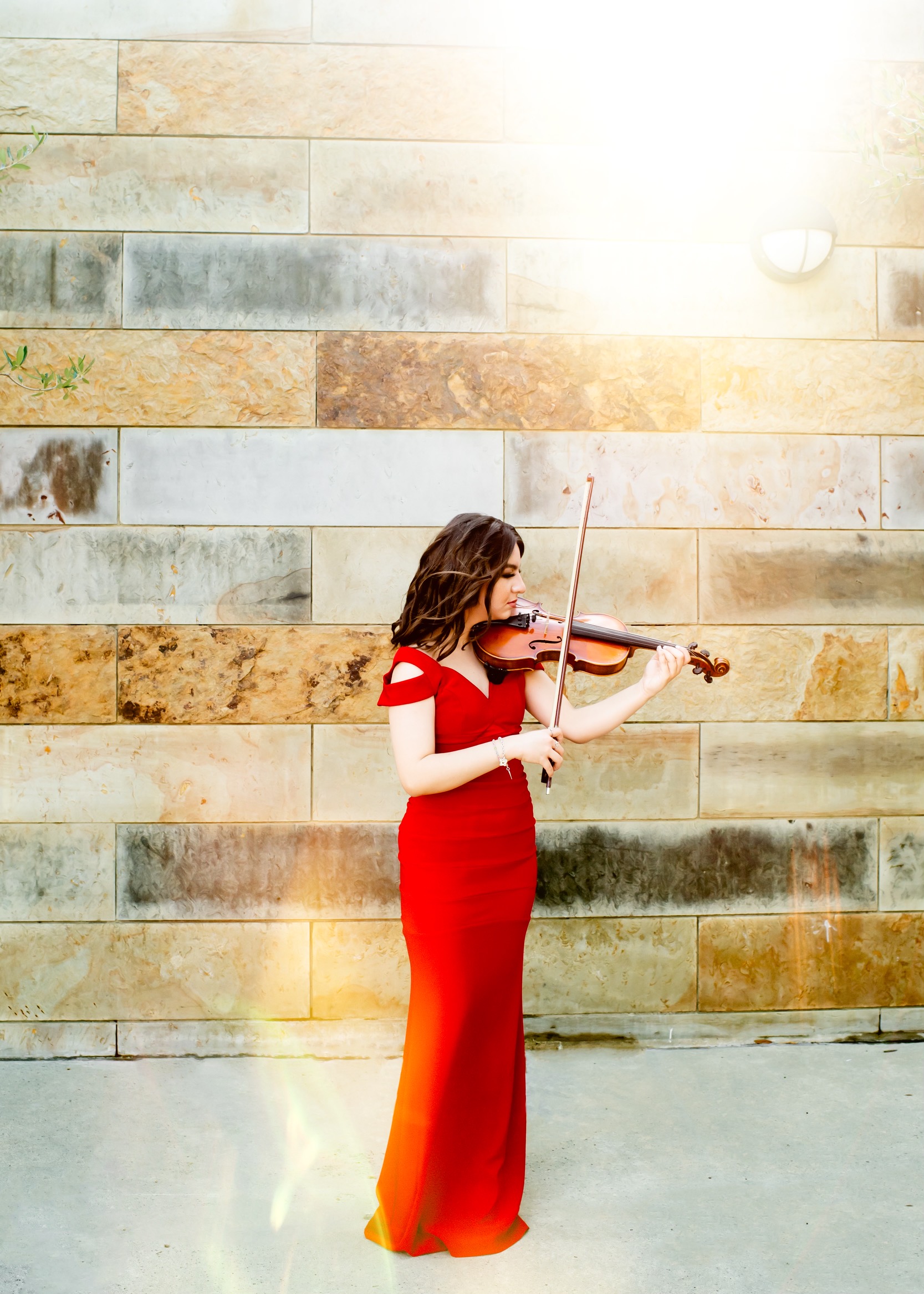 Girl in red dress playing violin