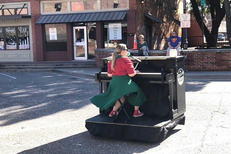 Woman playing piano at Christmas parade